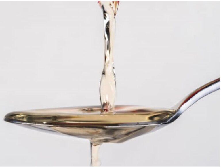 white/yellow liquid pouring over a spoon